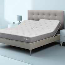 c1 smart bed mattress with gray tuffted headboard in a bedroom