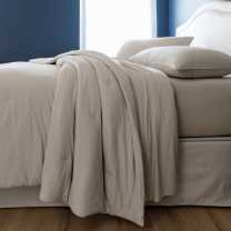 Sleep Number Cozy comforter in dark gray/fog stripes on a Sleep Number mattress