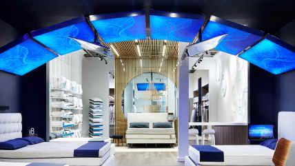 Inside a Sleep Number store showing beds, pillows, bedding