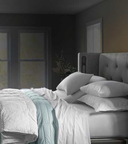 Lifestyle bed layered with Essential Fit sheets, basketweave blanket, printed duvet and Essential down alt comforter.