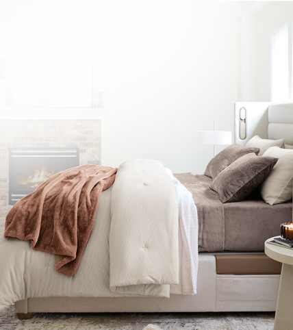Lifestyle bed layered with Essential Fit sheets, basketweave blanket, printed duvet and Essential down alt comforter.