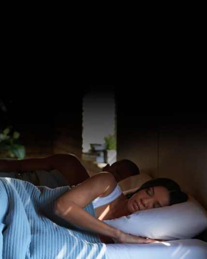 two people sleeping in bed