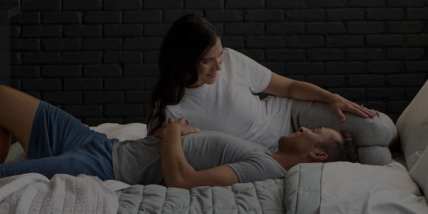 Couple sleeping under blanket