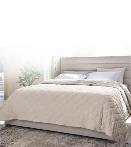 Dressed bed with blackberry plum grid stitch coverlet, clean asthetic