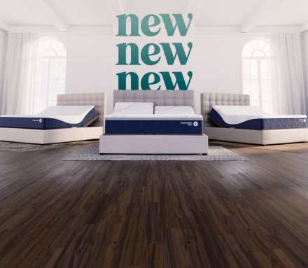 Three adjustable beds with blue‑and‑white mattresses displayed in a bright room, with the word ‘new’ repeated on the back wall.
