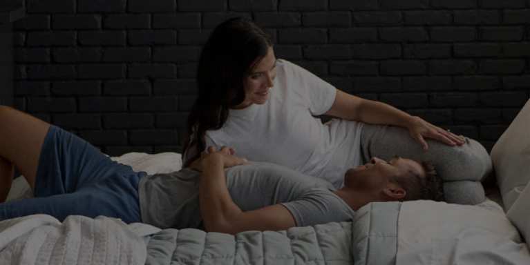 Couple sleeping under blanket