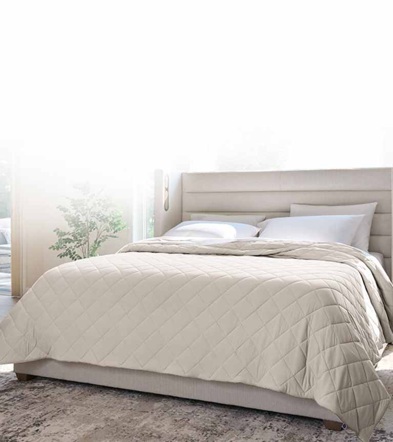 Dressed bed with blackberry plum grid stitch coverlet, clean asthetic