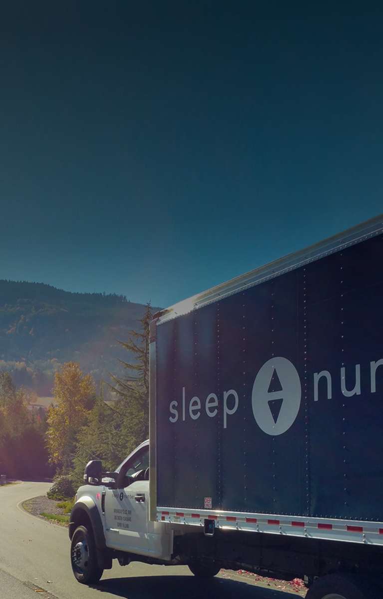 Delivery truck with Sleep Number logo displayed