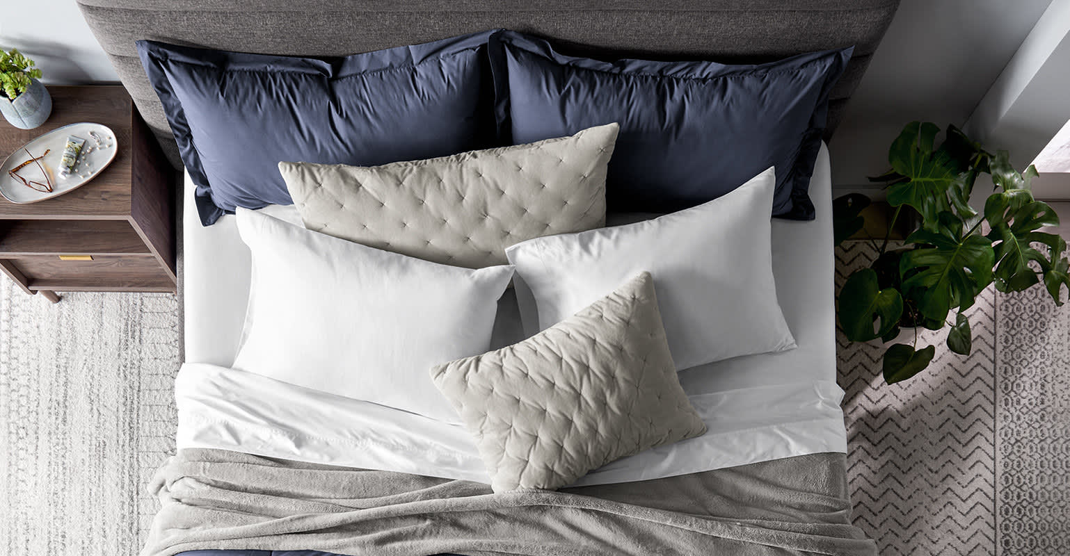 Pillows on dressed bed.