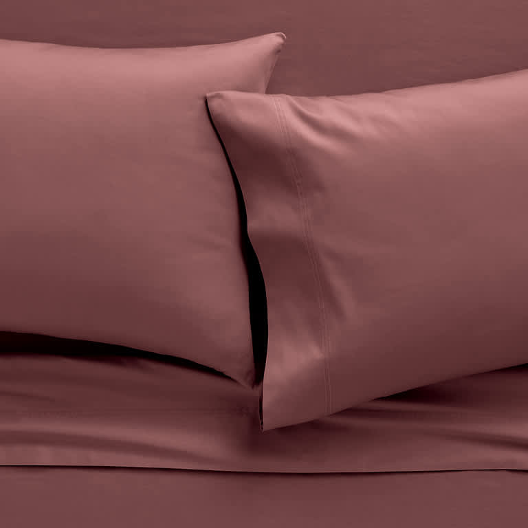 Colorful stack of sheets available in multiple colors and patterns, they are smooth, snug and secure with technology that moves with you as you sleep. 