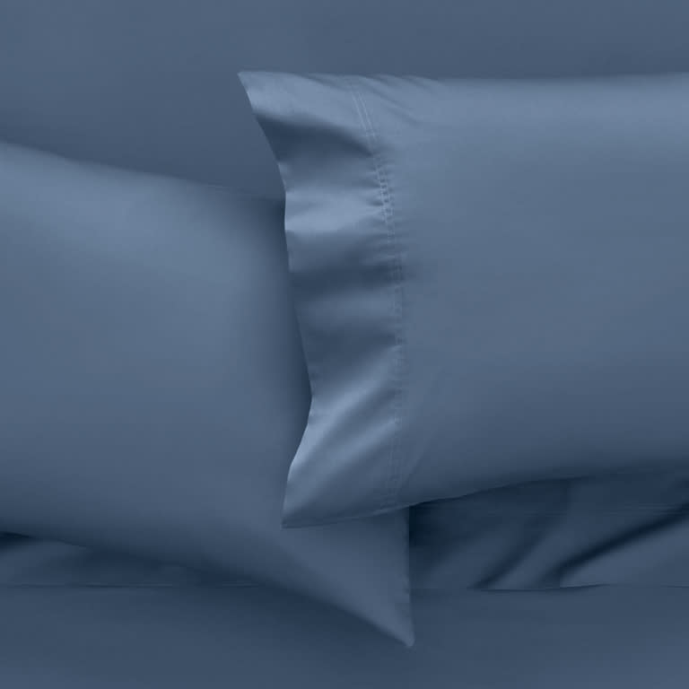 Temperature balancing bedding on a dressed bed to help keep you cool while you sleep 