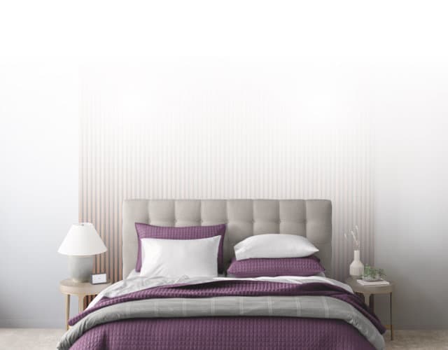 Dressed bed with blackberry plum grid stitch coverlet, clean asthetic