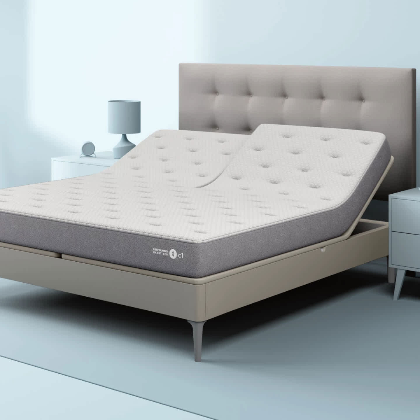 Sleep Number c1 smart bed with light grey tufted headboard