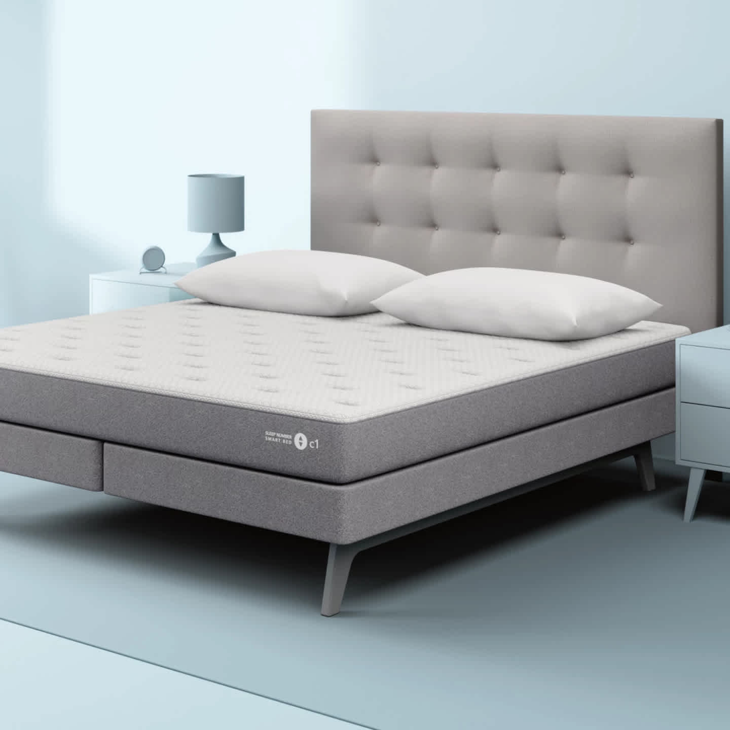 Sleep Number c1 smart bed with light grey tufted headboard