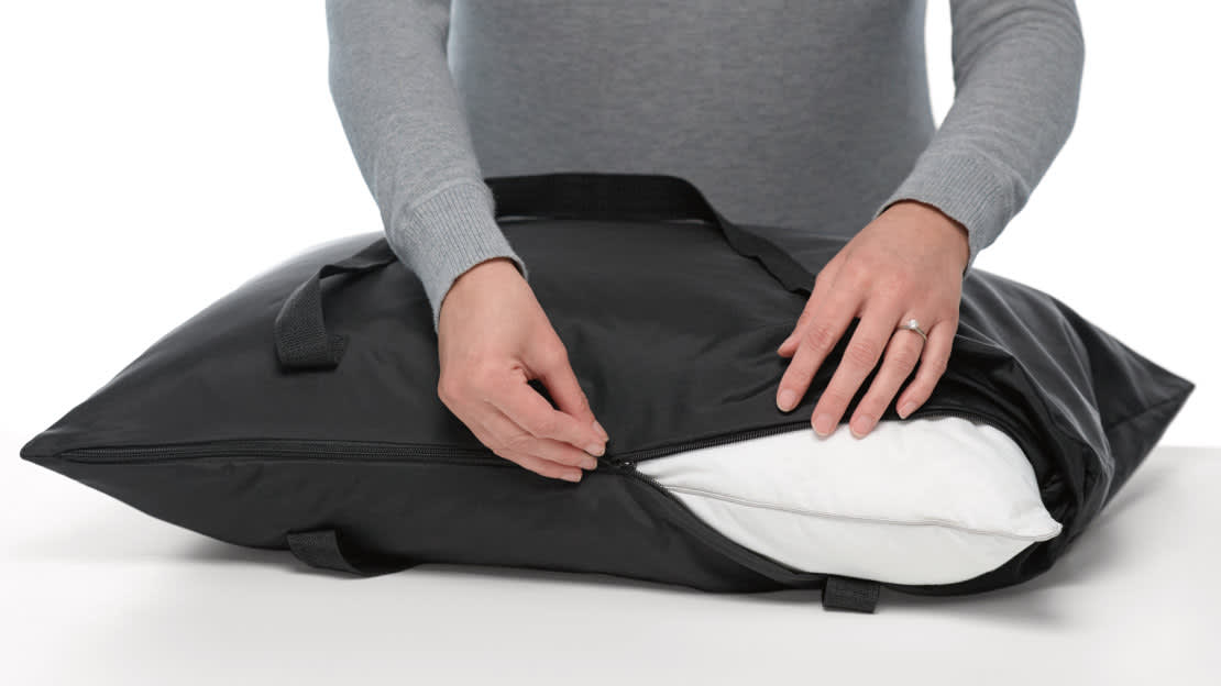 no peaking, image of person zipping the pillow tote around a pillow