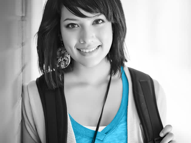 Student smiling while wearing a black back pack 