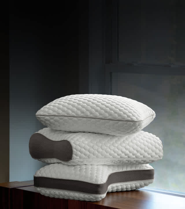 Stack of 3 ComfortFit pillows in standard, contour and ultimate shapes.