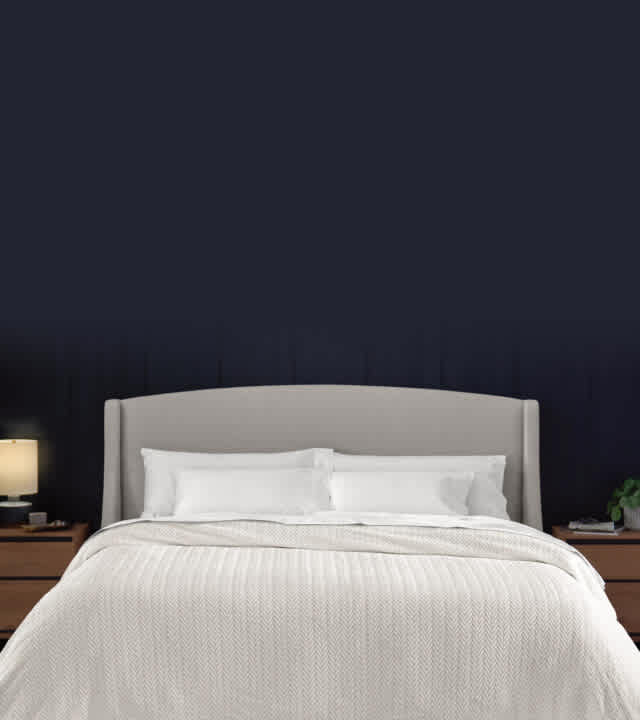 Dressed bed with blackberry plum grid stitch coverlet, clean asthetic