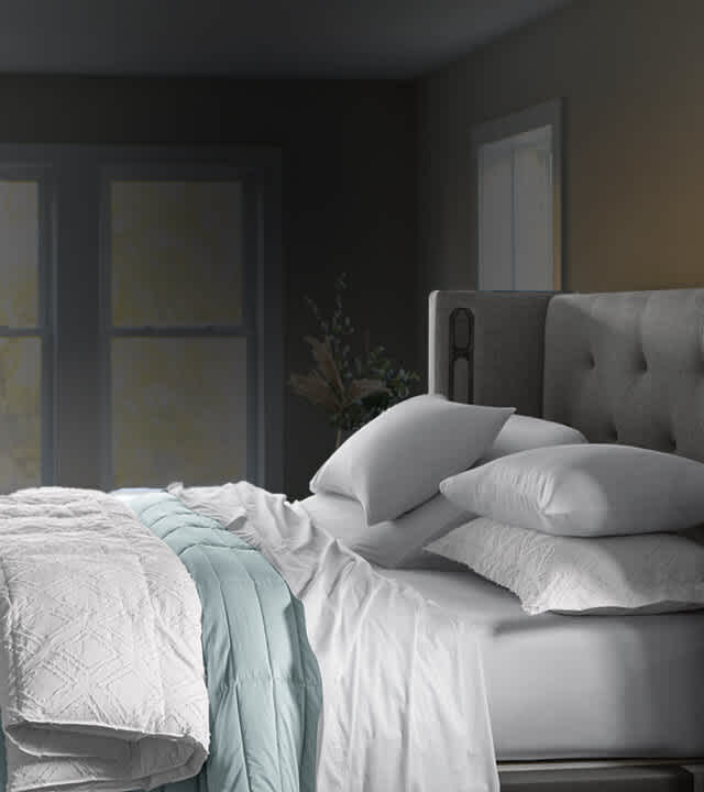 Lifestyle bed layered with Essential Fit sheets, basketweave blanket, printed duvet and Essential down alt comforter.