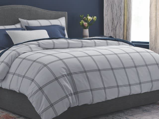 Image of corner of dressed bed, What is a duvet cover? It’s a removable cover that protects your comforter or duvet insert. Because it’s easier to wash, it can help extend the life of your comforter, and it adds color and style for a simple way to update the look of your bedroom. High-quality duvet covers such as ours include corner ties and zippers to keep the comforter fully enclosed and to prevent it from shifting within the duvet cover for comfort and even warmth distribution, link to shop now