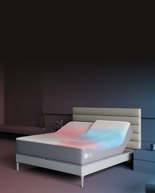 Adjustable smart bed in green bedroom with heads raised