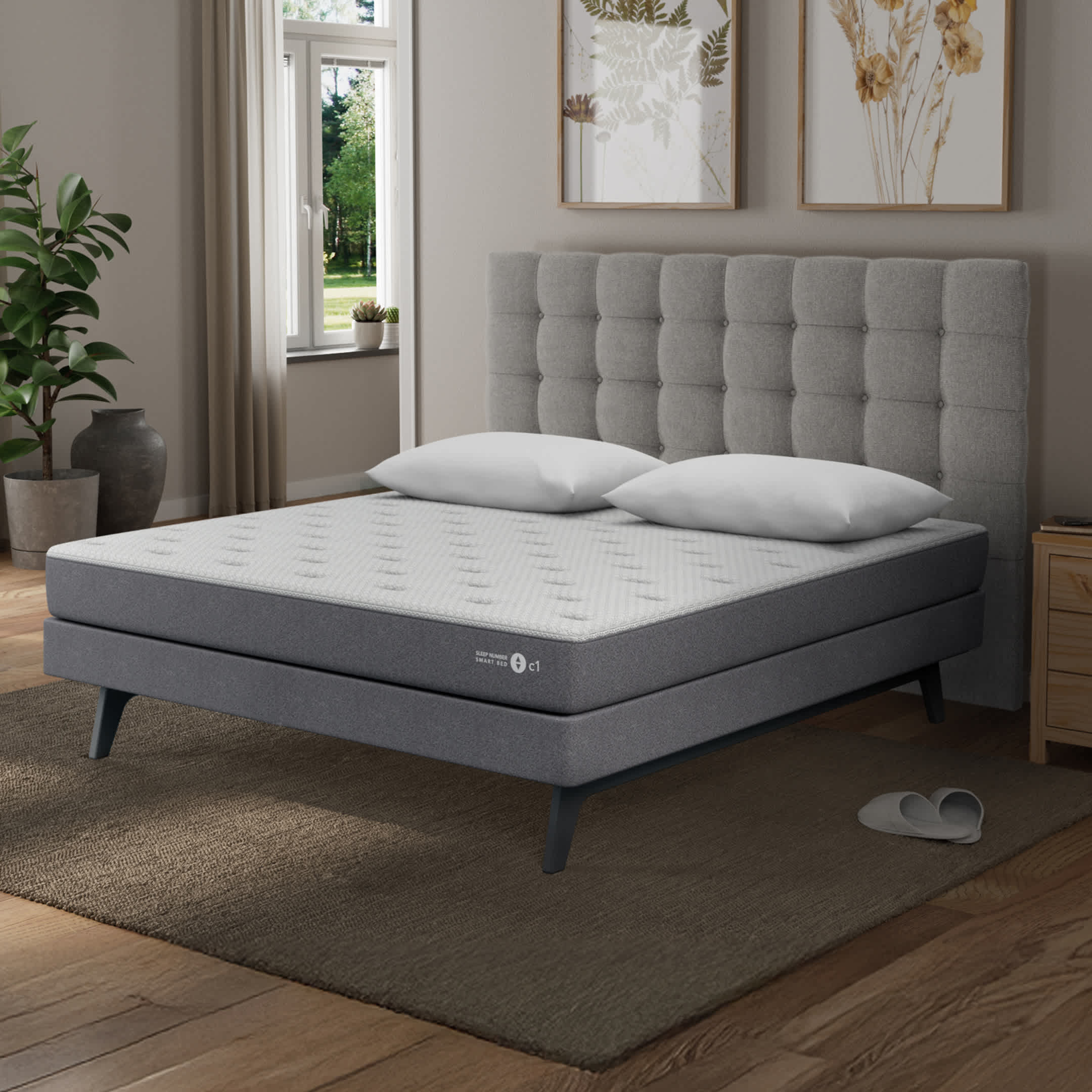 c1 smart bed mattress with gray tuffted headboard in a bedroom
